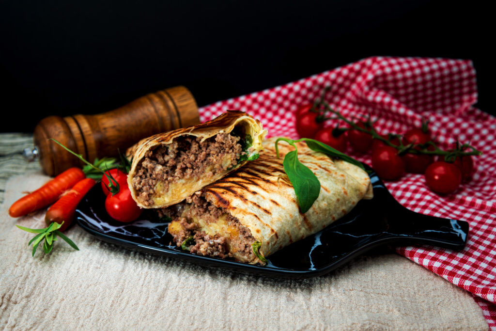 Beef tacos served with lettuce and fresh tomatoes